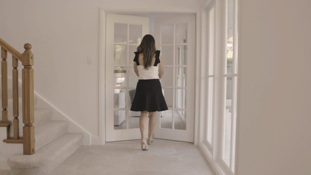Dea Manassen walking through a home