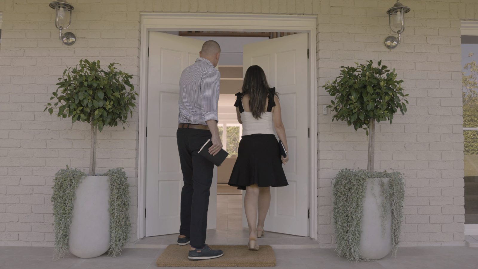 Dea and Mike Manassen arriving at a front door